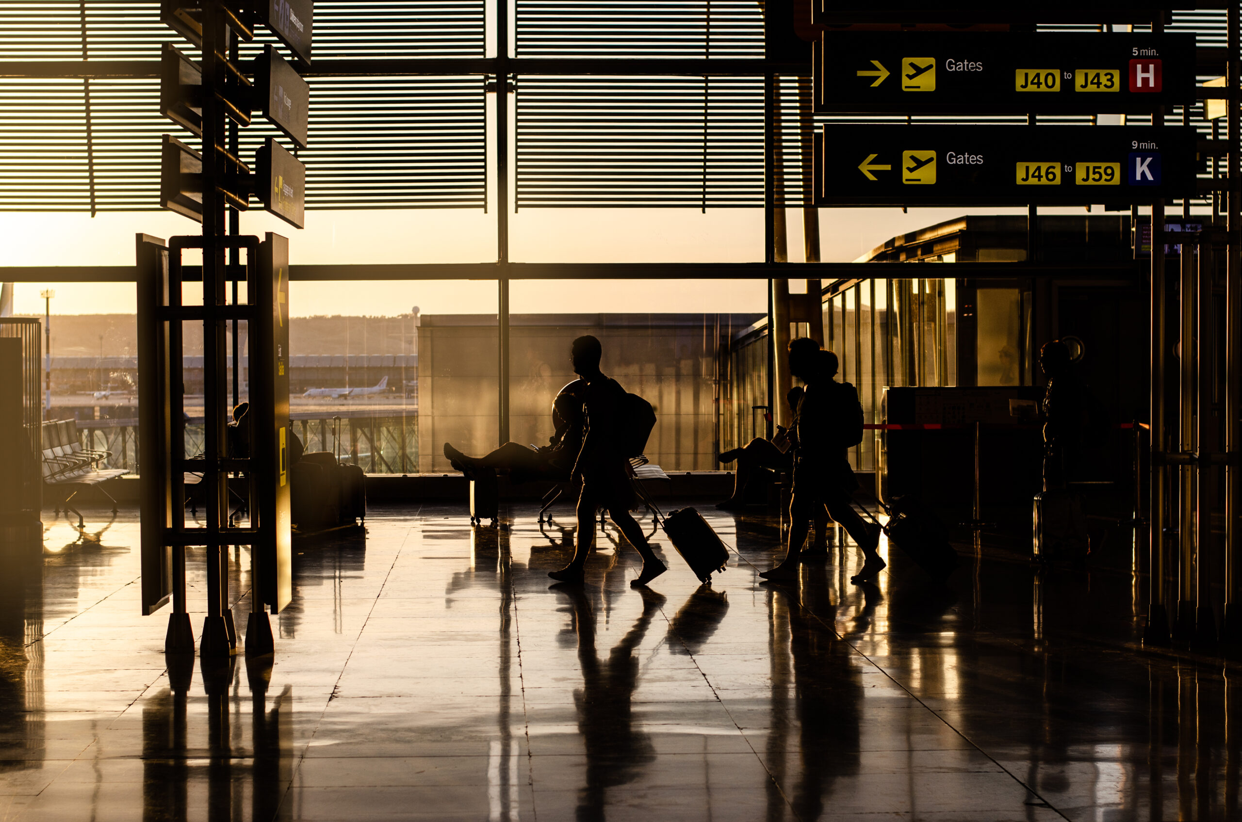 Silhouette of people walking inside a airport terminal