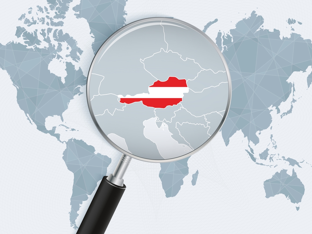 World map with a magnifying glass pointing at Austria. Map of Austria with the flag in the loop. Vector illustration.